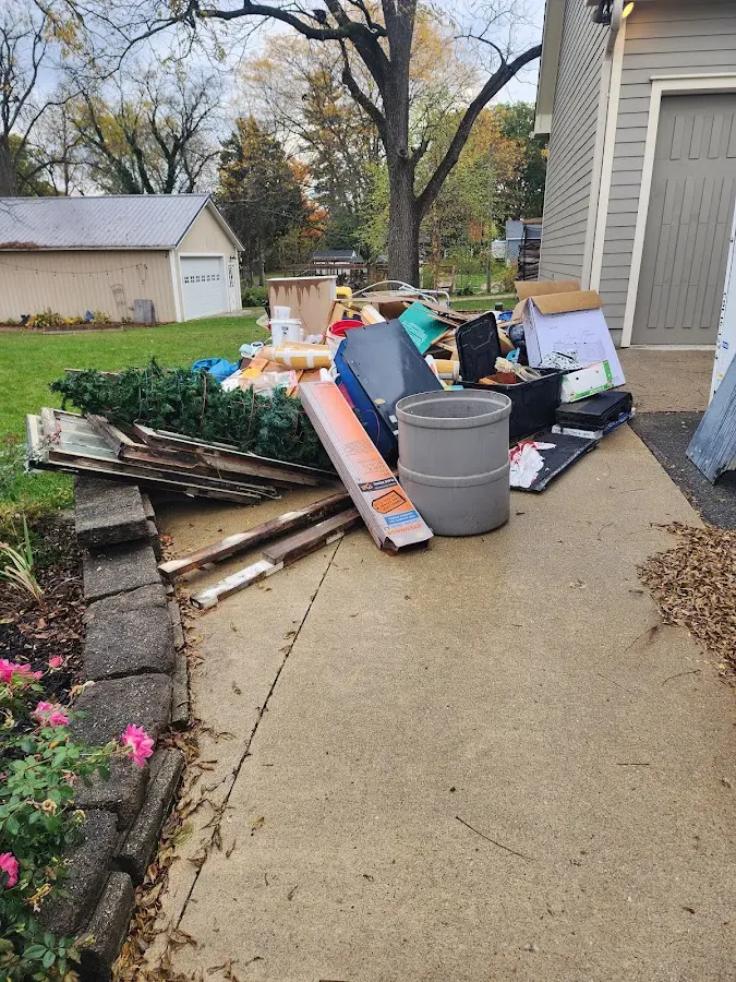 Dumpster being loaded with debris for Commercial Dumpster Rental in Milford